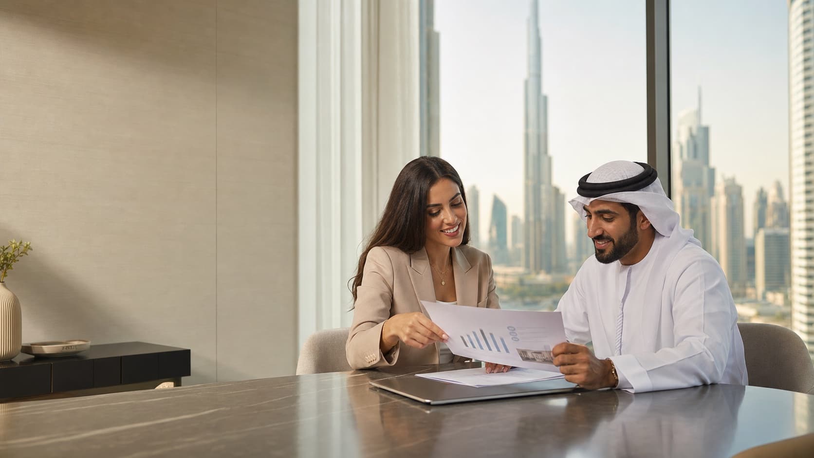 A property advisor reviewing a price report with a client in Dubai